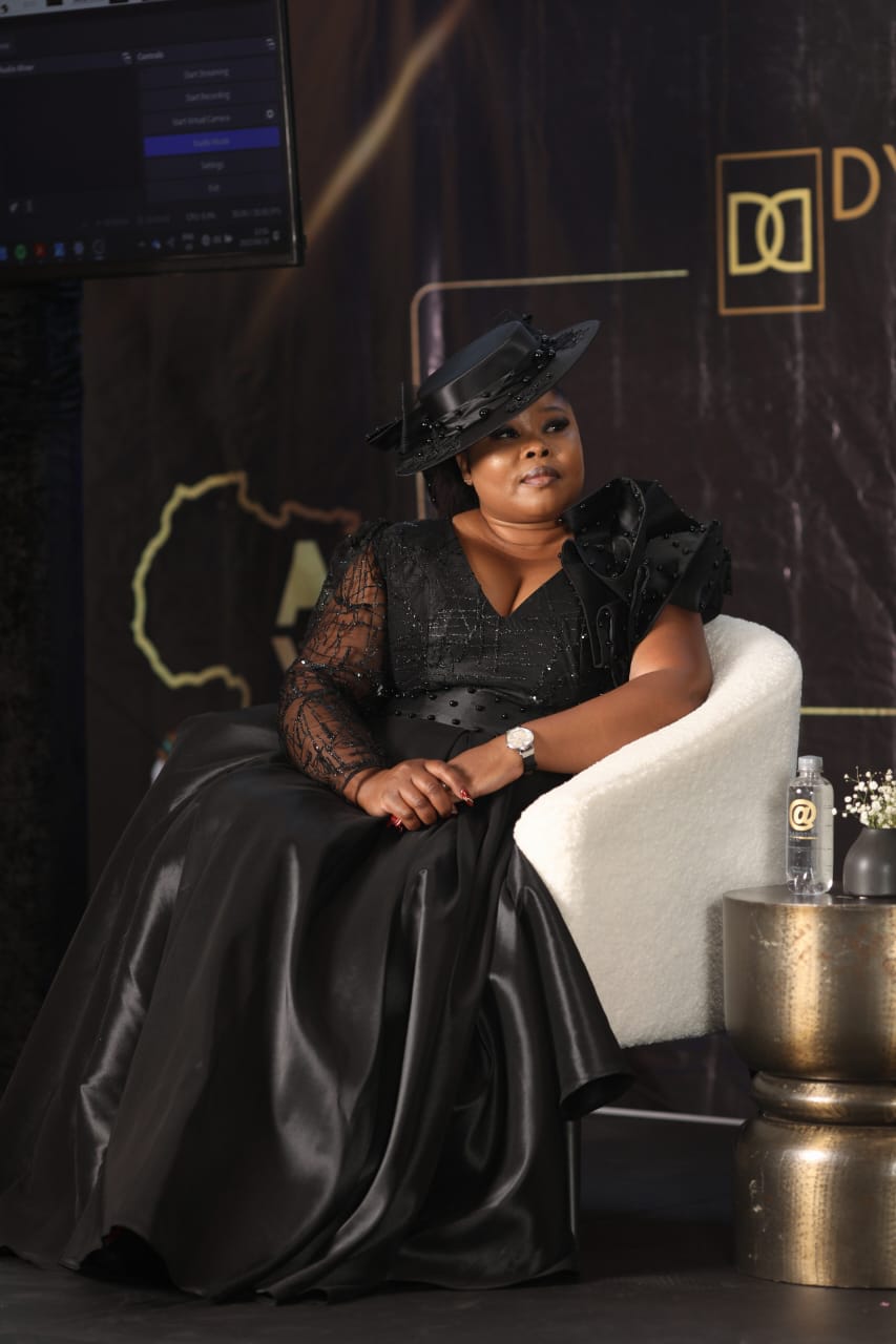 A seated portrait of a SheReign Africa guest on stage
